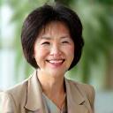 Portrait of Sarah Chen, 52, smiling warmly.